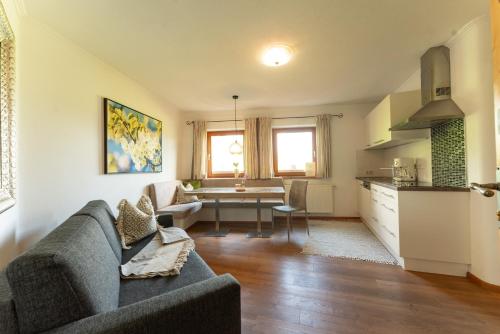 a living room with a couch and a table at Landhaus Trinker in Schladming