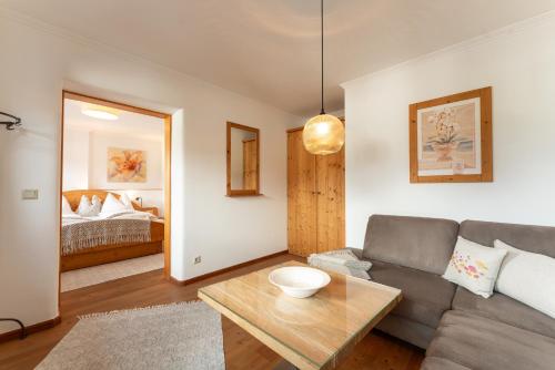 a living room with a couch and a table at Landhaus Trinker in Schladming