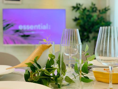a table with two wine glasses and plants on it at Cozy Erin Stay, Seoul in Seoul