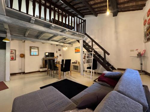 a living room with a couch and a staircase at Casa Matilde in Bassano in Teverina