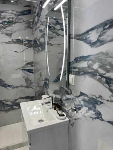 a bathroom with a sink and a mirror at Ble Property Atlas 8 in Loutraki