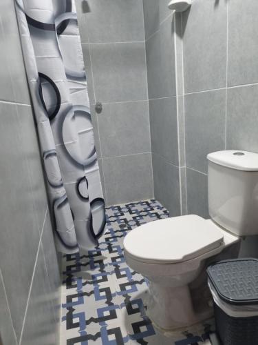 a bathroom with a toilet and a phone booth at Las Cascadas Hostel in Buritaca