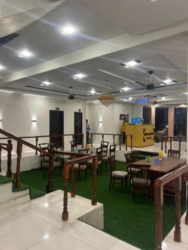 a dining room with wooden tables and chairs at Aquamarine Hotel Hoto in Skardu