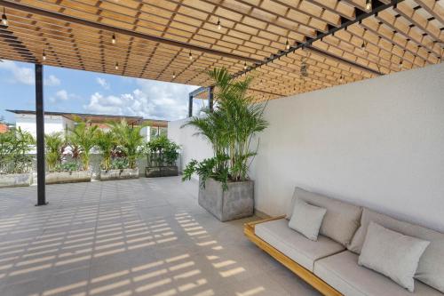 a living room with a couch on a patio at Stark villas - modern villa with roof top in Uluwatu