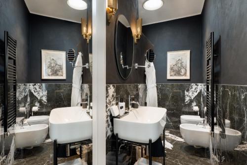 a bathroom with three sinks and two mirrors at 4F Boutique Hotel Florence in Florence