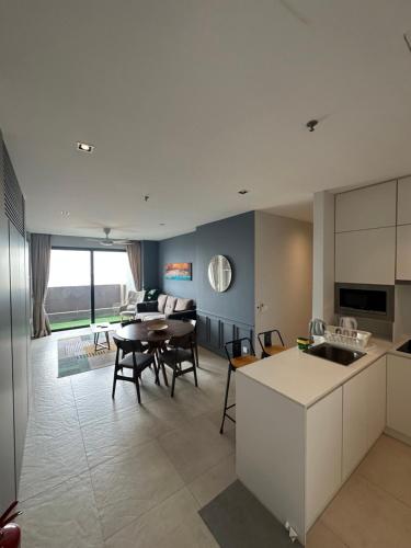 a kitchen and living room with a table and chairs at Lumi Tropicana - Idealhub in Petaling Jaya