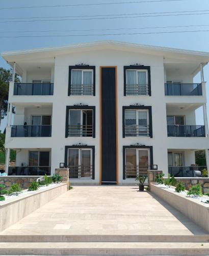 a white apartment building with black windows at Tikir House in Pamukkale