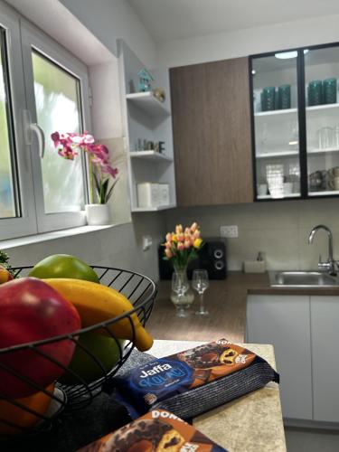 a kitchen with a bowl of fruit on a counter at Fisherman's House Gušti in Kamenari