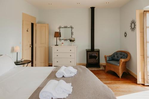a bedroom with a bed with towels on it at Casa do Sorrio - Slow Down, Live Now in Viana do Castelo