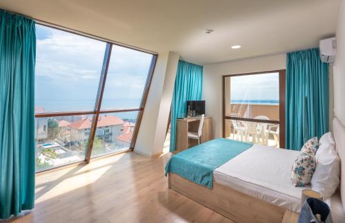 a bedroom with a bed and a large window at Sea View Hills in Sveti Vlas