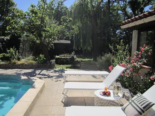 un jardin avec une piscine et une terrasse dans l'établissement Maison d'art et de nature - Luberon - Provence, à Robion
