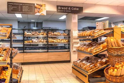 a bakery aisle with bread and cake on display at Brand new beachhouse Sand & Meer - Near beach in Bruinisse