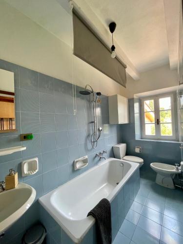 a bathroom with a tub and a toilet and a sink at Il Silenzio in Lucca