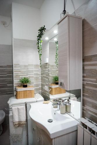 a bathroom with a sink and a mirror at House 416 Sweet Apartment in Perugia
