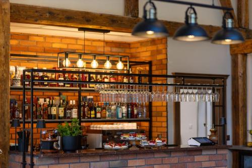 a bar with bottles and glasses on a shelf at Osada Prado in Michałkowa