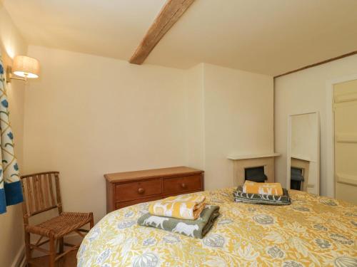 a bedroom with a bed with two pillows on it at Keepers Cottage in Devizes