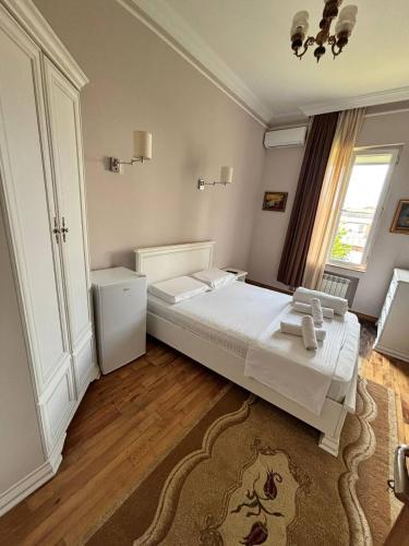 a bedroom with a large white bed and a window at Guest House Kobuleti 516 in K'obulet'i