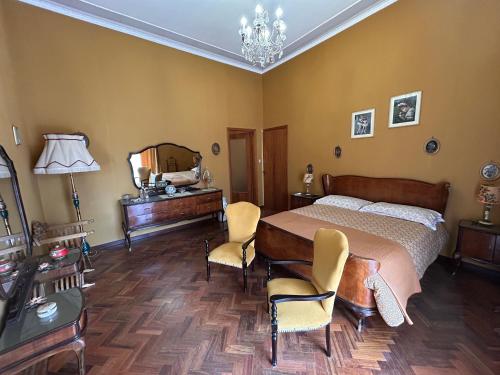 a bedroom with a bed and a table and chairs at Villa Sole in Randazzo