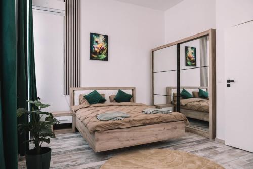 a bedroom with a bed and a large mirror at Casa Alecsandri -Ultra Central in Oradea