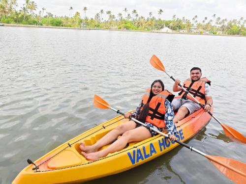 a man and woman in a kayak on the water at Vala House in Cherai Beach