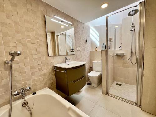 ein Badezimmer mit Badewanne, Waschbecken und Toilette in der Unterkunft Villa Marejadilla - Play San Juan - Sleeps 5 - Hot Tub - Sea Views in Playa de San Juan