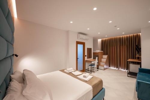 a hotel room with a bed and a living room at Vila Shpetimi in Ksamil