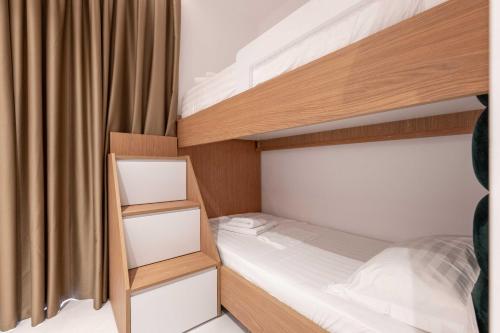 a bedroom with two bunk beds and a curtain at Vila Shpetimi in Ksamil