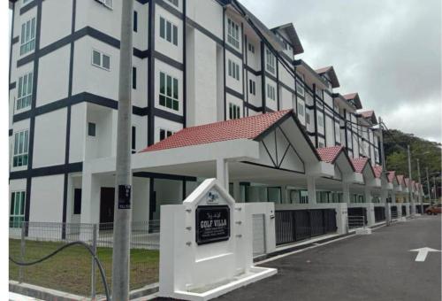 a building with a pay phone in front of it at Mossy Green Golfcourse Homestay in Tanah Rata