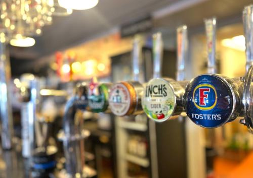 a close up of a row of cups on a bar at The Oakland Hotel in Woodham Ferrers