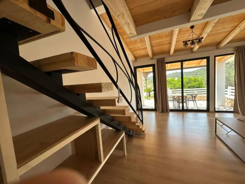a wooden staircase in a house with wooden floors at Vila Milo in Himare