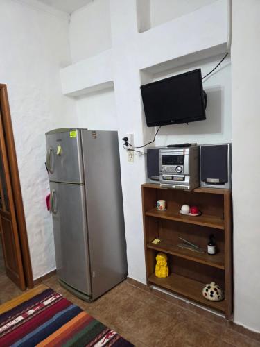 a kitchen with a refrigerator and a tv at Tolouse 1 in Tolosa