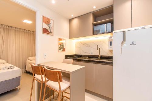 a kitchen with a table and chairs in a room at BSB STAY Torre Flats Particulares - Mercure Líder in Brasilia