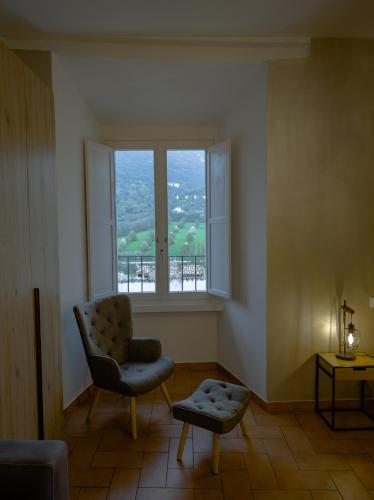 a living room with a chair and a window at Vicolo del Pozzo Suite in Spoleto