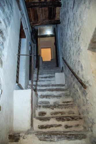 a stairway in an old building with stone stairs at Vicolo del Pozzo Suite in Spoleto