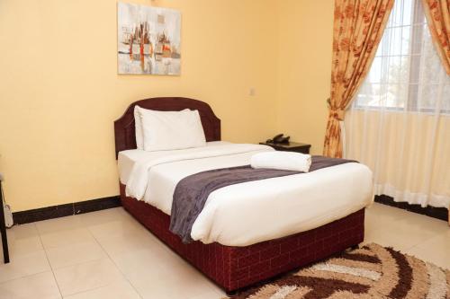 Postel nebo postele na pokoji v ubytování M Hotel
