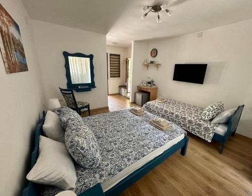 a living room with a bed and a couch at Kruna Palića in Palić