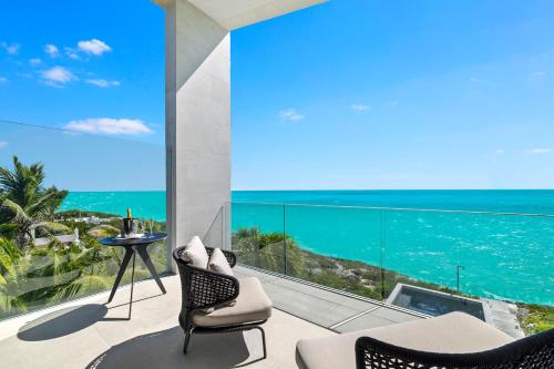 a living room with a view of the ocean at South Bank in Long Bay Hills