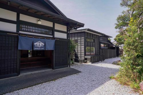 a building with a sign on the front of it at 旧邸貸別荘 南壽庵 in Tateyama