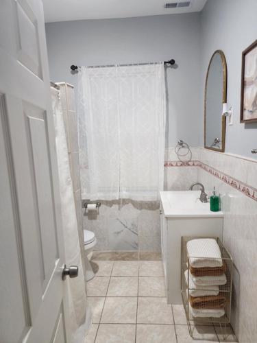 a bathroom with a shower and a sink and a toilet at Summer Sunset Hideout 1-2 Bedrooms and 1 Bath in Atlantic City