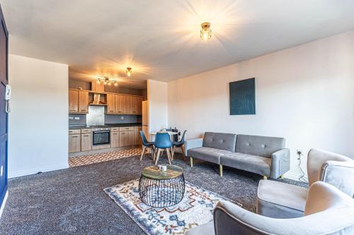 a living room with a couch and a table at Parkside Mayfair Apartment in Wakefield