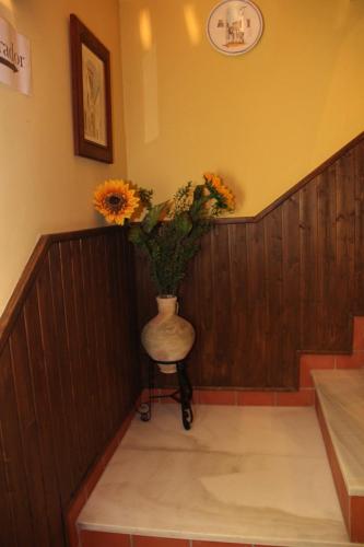 a vase of flowers sitting on a chair in a room at Casa Mirador San Pedro in Arcos de la Frontera