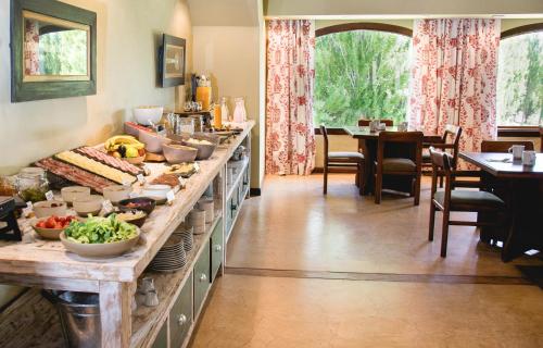 a kitchen with a buffet with food on it at Kau Yatún Hotel Boutique in El Calafate