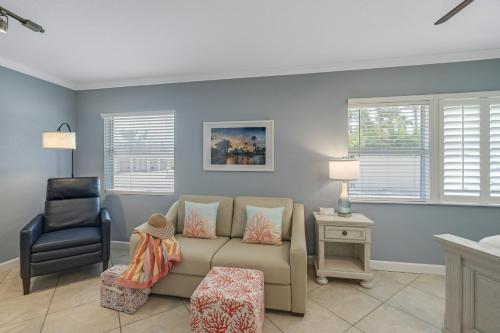 a living room with a couch and a chair at Tropical Beach Resorts - Sarasota in Sarasota