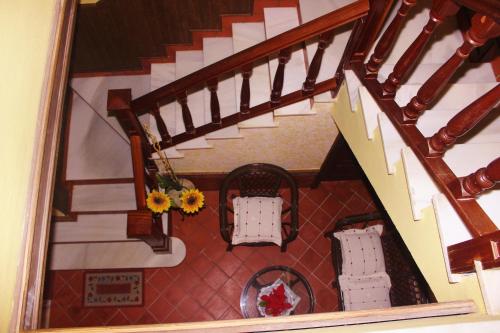 a view of a room with two chairs and a staircase at Casa Mirador San Pedro in Arcos de la Frontera