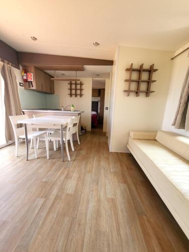 a living room with a table and chairs and a couch at VioVillas Agriturismo Glamping Arezzo in Arezzo