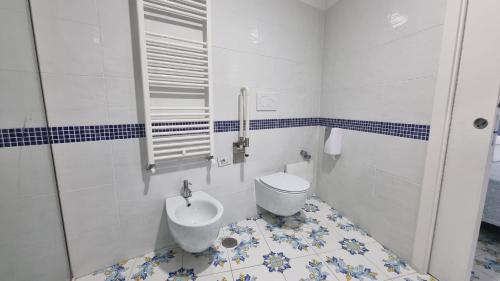 a bathroom with a toilet and a sink at Hotel Giosue' a mare Sorrento in Meta