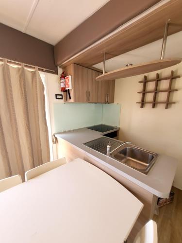 a small kitchen with a sink and a counter at VioVillas Agriturismo Glamping Arezzo in Arezzo