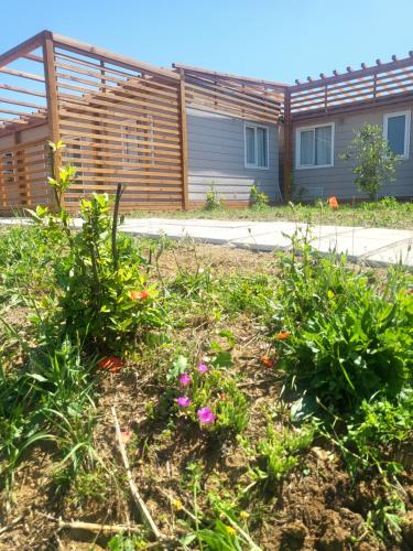 a garden with flowers in front of a building at VioVillas Agriturismo Glamping Arezzo in Arezzo