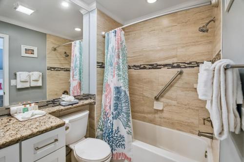 a bathroom with a tub and a toilet and a shower at Tropical Beach Resorts - Sarasota in Sarasota