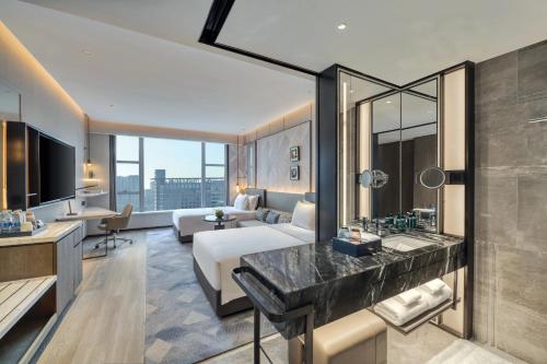 a hotel room with a bed and a bathroom at Crowne Plaza Rugao in Nantong